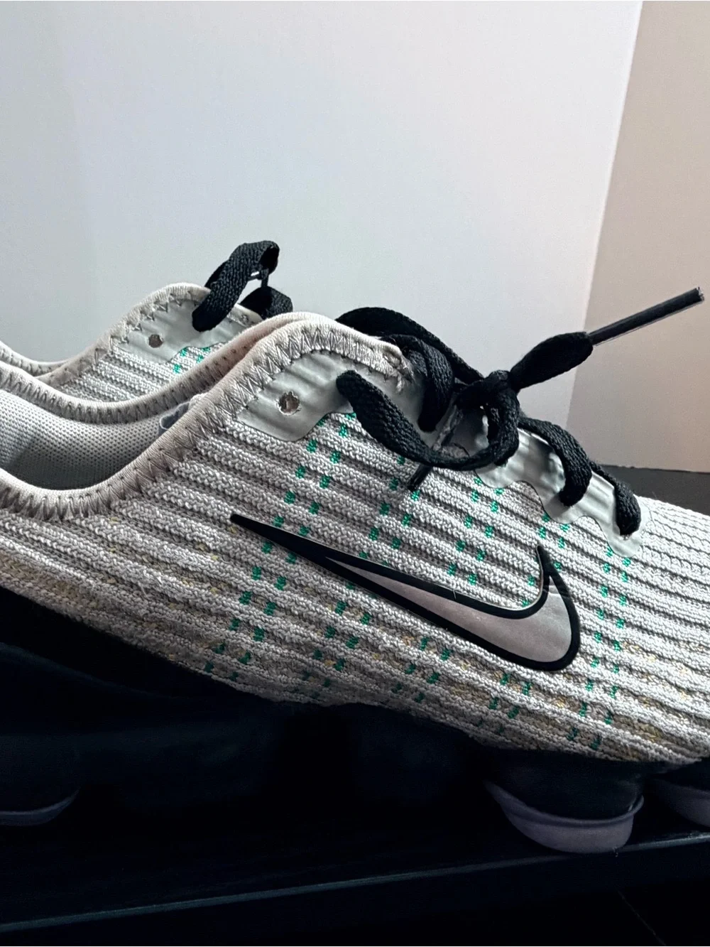 Nike Men’s White Knit Sneakers with Black Accents and Teal Dots